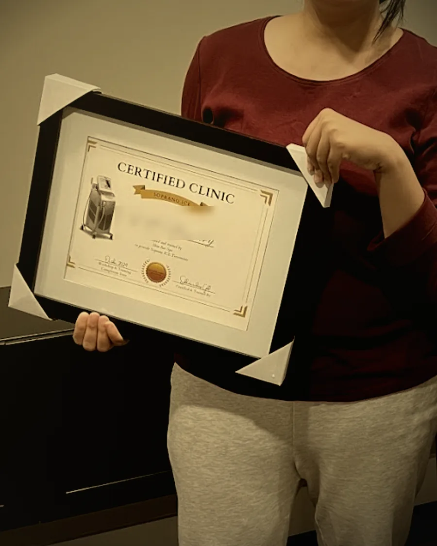 A Skin Bar Spa graduate holding her Soprano ICE certification